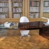 Distinguished Reflex Pegaso desk with dark wood grain and sleek glass surface, exhibiting an asymmetric design with integrated drawer and high-gloss sheen