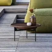 Distinguished GART Gió coffee table, low circular dark-brown eco-polyurethane top, matte finish, thin dark-metal tripod base