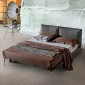Luxury Alivar Papillon Bed with charcoal‑tinted leather headboard, texture, aluminium legs, brown and light‑grey linens