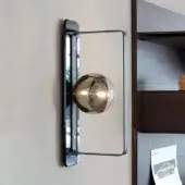 Distinguished Reflex Oh wall lamp with brass metal and bronze mirror, showcasing integrated G9 LED lighting in a borosilicate glass sphere