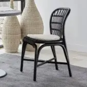 Architectural Gervasoni Santé chair in matte black woven Manau rattan with curved backrest and off-white upholstery