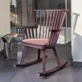 Sophisticated Gervasoni Gray 29 rocking chair crafted from deep dark reddish-brown ash wood with multi-colored textile cushion