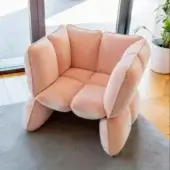 Captivating Furla Casa Fiore lounge chair in soft pale pink smooth fabric with metal frame and organic petal-like segments