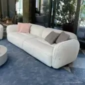 Sophisticated Furla Casa Moonstone sofa in cream textile with low profile organic silhouette and black beech wood feet