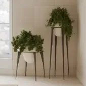 Sophisticated PIMAR Capasa vase set in organic cream stone basins within minimalist charcoal iron frames