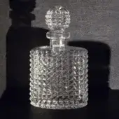 Exquisite John Richmond bottle in clear 24% lead crystal with geometric hobnail pattern and matching spherical stopper
