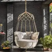Exceptional Roberti Rattan Gravity lounge chair with a stainless steel frame, golden finish, and light grey cream cushions