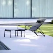 Elegant Royal Botania QT lounger with a curved black metal frame and durable Batyline seat in a matte finish