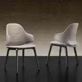 Superior Reflex Vela chair with sculpted resin shell, quilted backrest and smooth light beige upholstery supported by dark matte metal legs