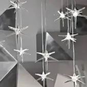 Elegant Reflex Stella suspension lamp with multiple transparent Pyrex glass star pendants and glossy silver-toned wires