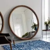 Exceptional Porada Giove mirror crafted in solid Canaletto walnut with a smooth satin finish and generous circular glass