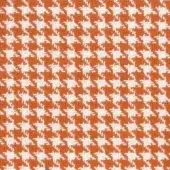 Houndstooth textile with white and burnt orange repeating pattern; woven fabric features irregular four-pointed motifs and a slightly raised texture.