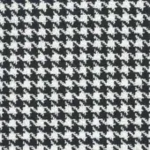 Houndstooth textile sample in black and off-white with interlocking diamond shapes, dense repeating motif on charcoal gray, Mariani fabric.