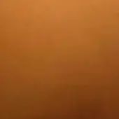 Earthy gradient texture displaying warm orange tones, transitioning from saturated to muted, with a smooth, porous surface and subtle grain.