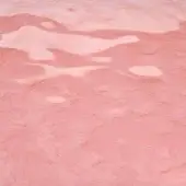 Cast glass texture, pink, mottled surface with irregular indentations and diffused light creating a marbled, organic appearance.