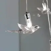 Exclusive Reflex Rondini suspension lamp with delicate swallow pendants crafted in transparent and black Murano glass with glossy finish