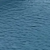 Blue water texture displaying small ripples, a dynamic pattern, and a lighter central disturbance, with a matte, natural finish.