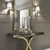 Superior DV Home Collection Kent Plus console with a dark wood tabletop and elaborately curved stainless steel base in a polished gold-tone finish