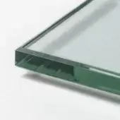 Clear glass sheet with beveled edges displayed against a white backdrop, exhibiting light refraction and transparency.