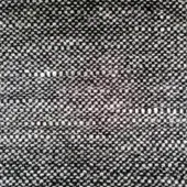 Woven fabric sample, gray and black, irregular dot pattern; dense plain weave texture with visible threads, matte finish, “ditre italia” label.