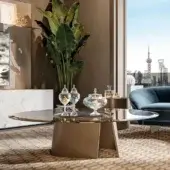 Exceptional Reflex Esse table with a satin brass base and bronze glass top exhibiting a beveled edge