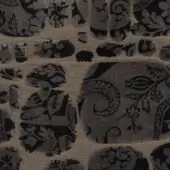 Beige velvet fabric swatch, “le pas des anges” collection, with dark gray medallions featuring stylized foliage and a dense, ornate design.