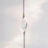 Nickel sculptural lighting fixture with elongated stem and clear resin form, displaying internal striations and a diamond-like void.