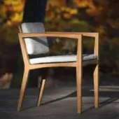 Harmonious Royal Botania Zenhit armchair crafted with teak wood and light gray textile upholstery in a medium-warm brown finish