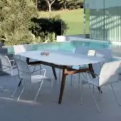 Refined Royal Botania Zidiz table crafted with teak wood and a smooth white ceramic tabletop exhibiting clean lines