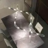 Captivating Reflex Firefly suspension lamp crafted in transparent blown glass with a polished chrome metal framework
