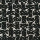 Woven tweed-like fabric texture with black and off-white irregular pattern, dense weave, subtle sheen, and “tammy” p 067 label.