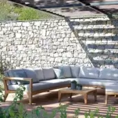 Sophisticated Royal Botania Zenhit sectional with teak wood frame and plush fabric seat cushions in light gray tones