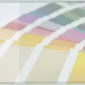 Back painted glass RAL chart with rectangular color swatches in gradient from yellow to gray, featuring vertical white stripes on a neutral background.