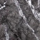 Grigio Carnico marble texture with dark gray base, black veining, and white streaks displaying a polished, web-like pattern.