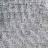 Herringbone fabric texture in light gray with tonal variations and dark flecks, displaying a dense, raised woven structure.