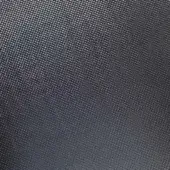 Dark gray woven texture with a repeating geometric pattern, exhibiting a dense, matte finish and subtly raised, uniform surface.