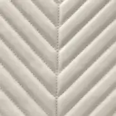 Quilted leather texture in pale gray features a chevron stitch pattern, displaying subtle contrast and a polished sheen, indicative of refined craftsmanship.