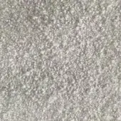 Rug, light gray, dense granular texture with irregular bumps; indoor fabric surface displaying subtle tonal variations and diffused lighting.
