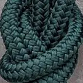 Rugiano outdoor rope rug, dark green polypropylene, tightly coiled circular shape with visible woven texture and knotted intersections.