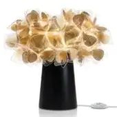 Slamp Clizia table lamp, black conical base, gold translucent leaf canopy with integrated warm LED lights, studio shot.