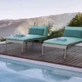 Elegant Roberti Rattan Key West lounger with hand-woven Sunrope seating and powder-coated aluminum frame in beige and teal