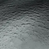 Grayscale water droplet texture displaying varied gray tones, with irregular patterns and diffused lighting across a reflective surface.