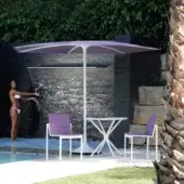 Innovative Royal Botania Palma umbrella with cantilevered form and muted lavender textile canopy in a smooth matte finish