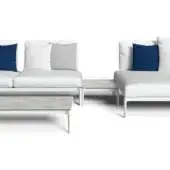 Modular sectional sofa, white frame, light gray upholstery, with navy and gray pillows, and marble-top coffee table, studio shot.