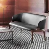 Exceptional Potocco Velis sofa with enveloping form built in dark leather and medium-tone Canaletto walnut or ash with satin finish