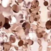 Terzani Argent chandelier, rose gold plated, cascading layers of polished metallic leaf-like components against a blurred backdrop.