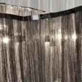 Chainmail curtain, silver finish, vertical cascade with black ribbon; layered texture, bright highlights, Terzani Atlantis black nickel.