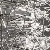 Terzani Core chandelier, nickel-plated metal, geodesic structure with clear glass shards, studio lighting, reflective geometric design.