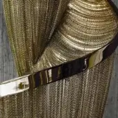 Terzani Epoque pendant light in brushed bronze features layered metallic elements, a polished band, and a textured vertical pattern.