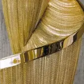 Terzani Epoque Gold Plated hand sculpture with striated texture, stainless steel wrist band, and brushed gold finish against a gray backdrop.